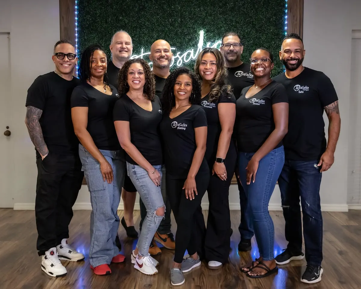 The Tato Salsa staff smiling together in the studio.